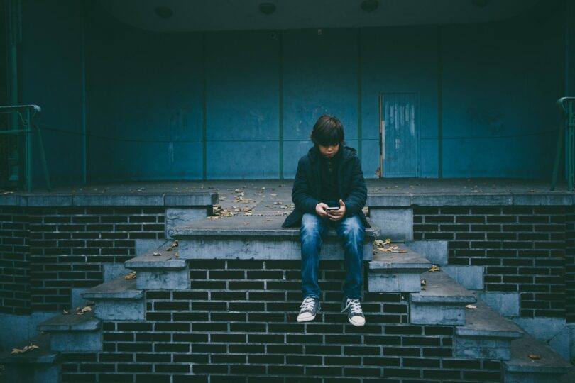 boy alone with phone- dealing with passive disobedience