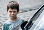 angry boy by car - how to parent overt disobedience
