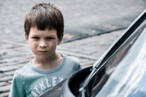 angry boy by car - how to parent overt disobedience
