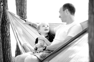 father and son in a swing- job of a christian parent
