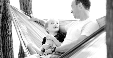 father and son in a swing- job of a christian parent